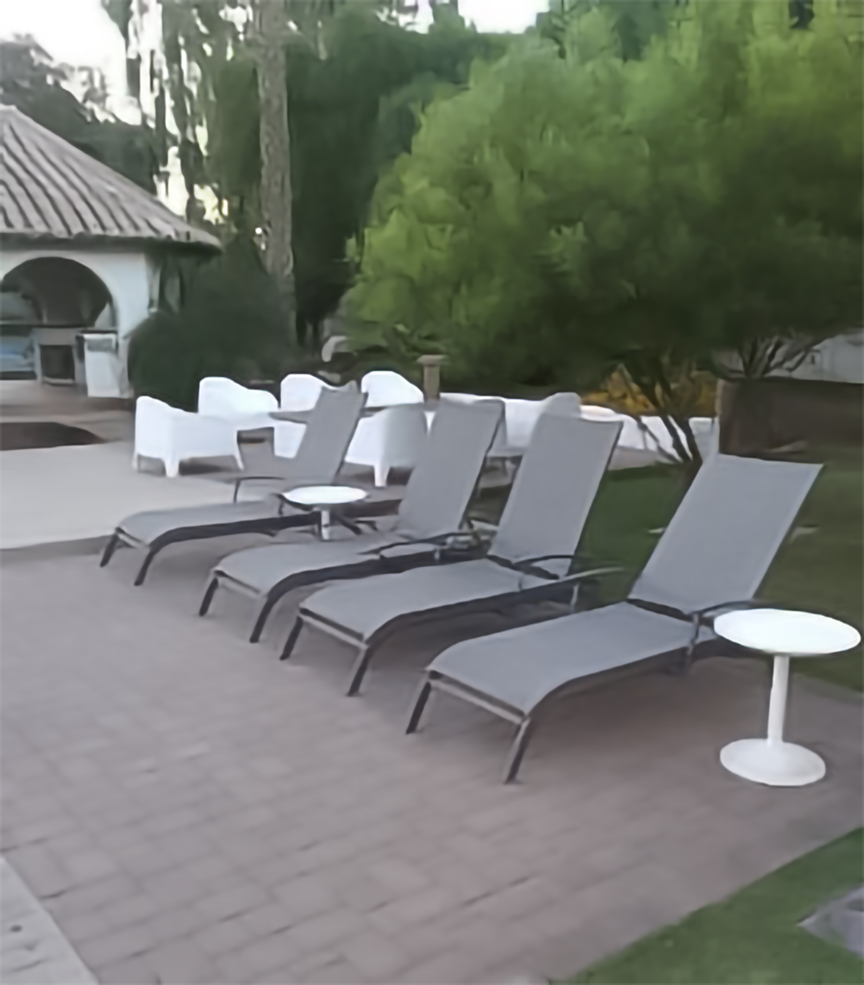 Perfectly arranged pool lounge chairs — vacation rental outdoor cleaning